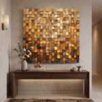 Abstract wall art of textured wood cubes above a walnut console table in a warm modern hallway