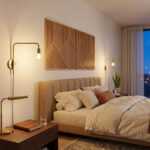 Geometric wood wall art above a beige upholstered bed in a warmly lit modern bedroom