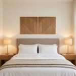 Geometric wood wall art panels above a neatly styled bed in a warm modern bedroom
