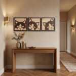 Wood wall art featuring three cat head designs displayed above a wooden console table in a cozy entryway.