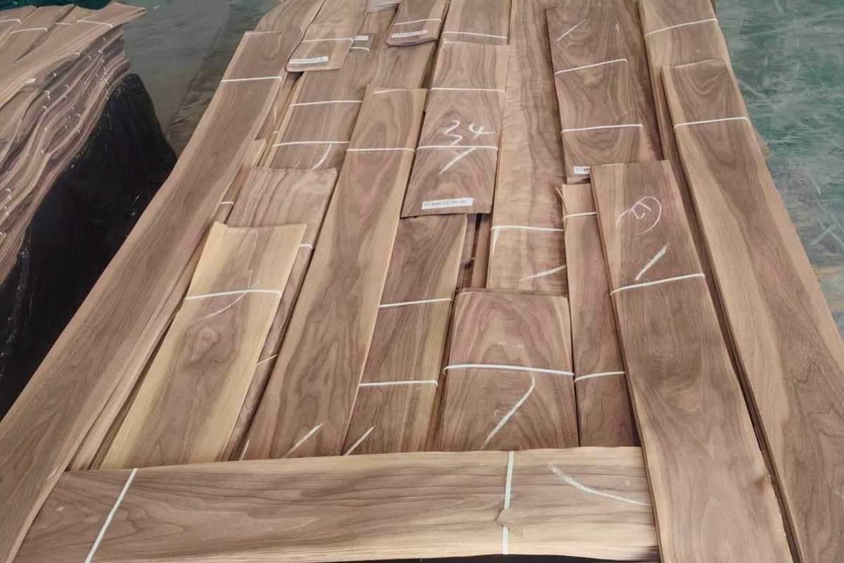 Bundles of natural walnut lumber boards stacked in a workshop