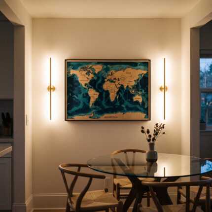 World map wall art above a glass dining table in a warmly lit modern dining room