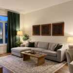 Islamic wall art panels above a gray sofa in a warm modern living room